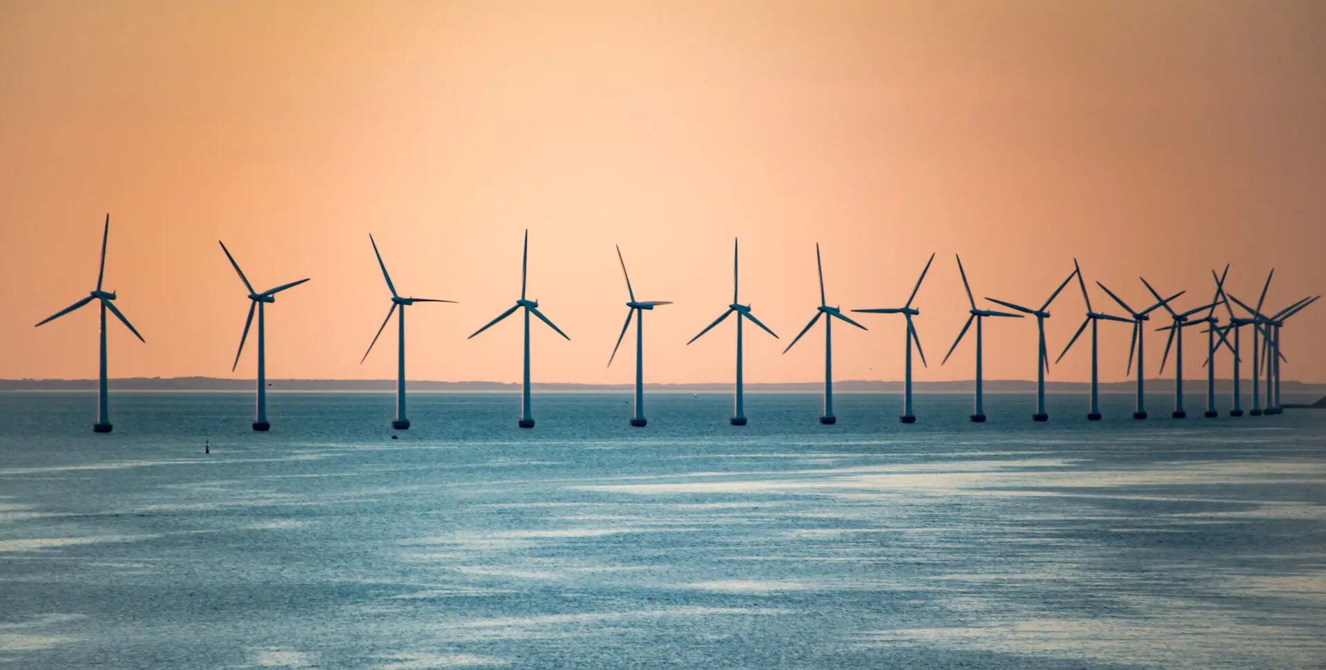 windmills-offshore-with-sunset