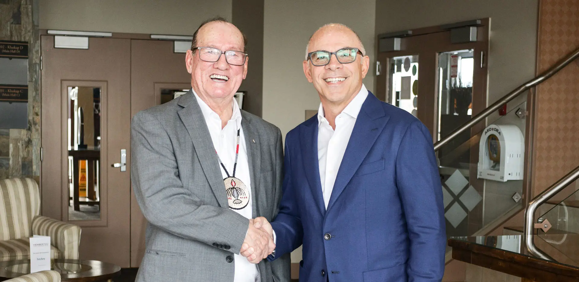 Chief Terry Paul of Membertou and Albert Barbusci shaking hands.